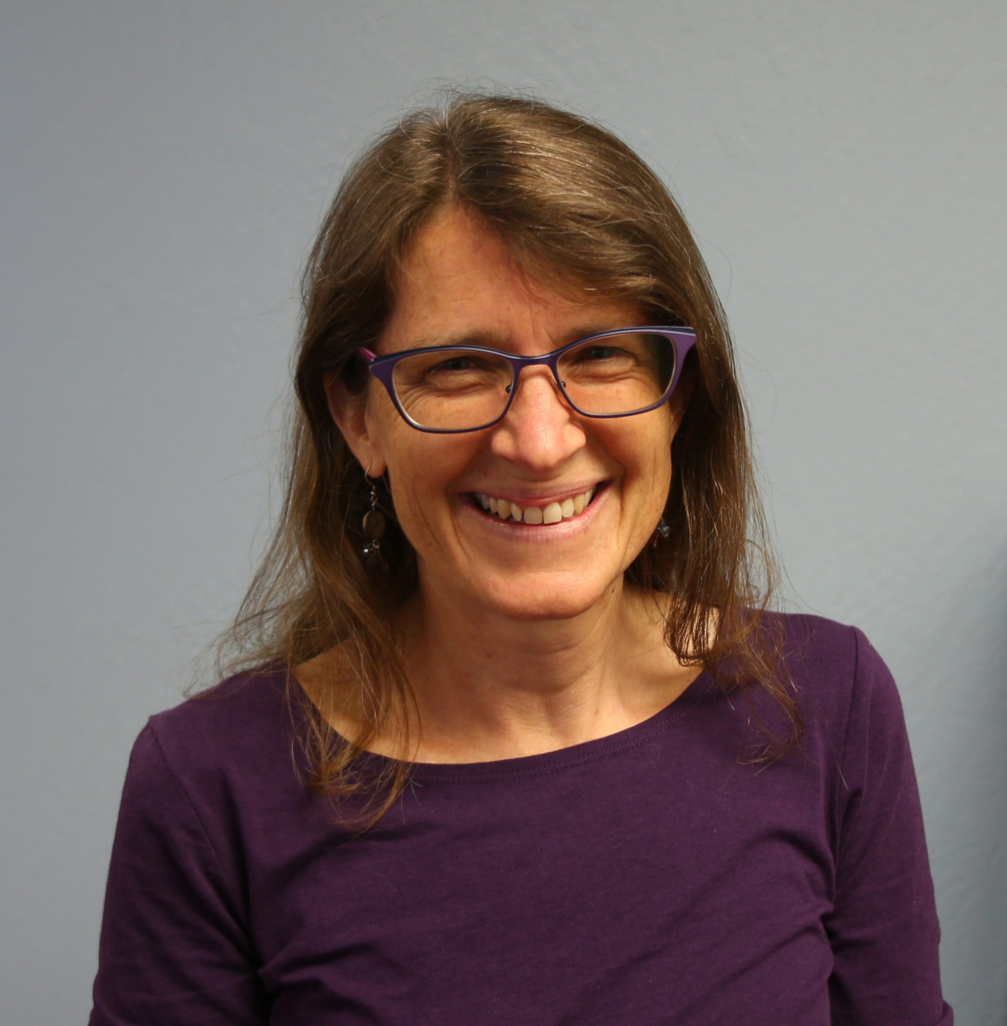 Photo of a woman wearing a purple shirt